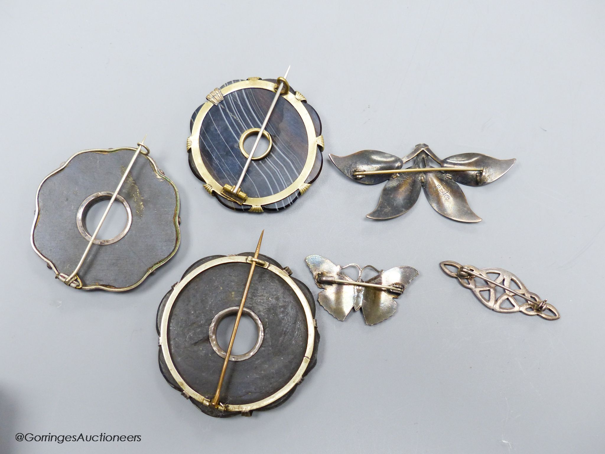 Two sterling and enamel brooches, including butterfly, 37mm, one other white metal brooch and three hardstone set brooches.